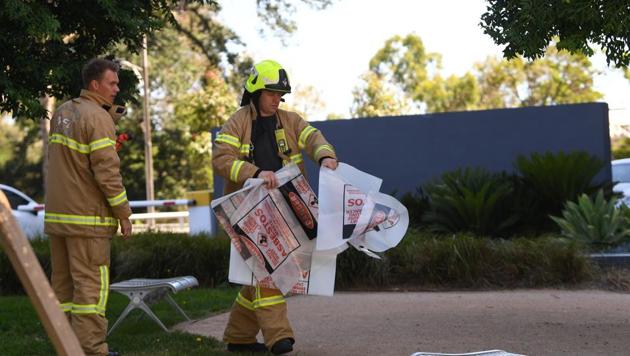 A fire fighter is seen carrying a hazardous material bag into the Korean consulate in Melbourne on Wednesday.(AP) A fire fighter is seen carrying a hazardous material bag into the Korean consulate in Melbourne on Wednesday.(AP)