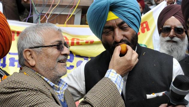Suspended AAP Patiala MP Dr Dharamvira Gandhi offers sweets to Sukhpal Singh Khaira during the launch of Punjabi Ekta Party in Chandigarh on Tuesday. (Keshav Singh / HT Photo) Suspended AAP Patiala MP Dr Dharamvira Gandhi offers sweets to Sukhpal Singh Khaira during the launch of Punjabi Ekta Party in Chandigarh on Tuesday. (Keshav Singh / HT Photo)