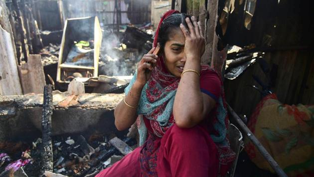 A woman wails near the site of a gas cylinder blast, in a slum colony at Sector 19 of Kopar Khairane area, in Navi Mumbai. At least 20 shanties were destroyed in a fire on Wednesday in a slum colony, officials said, in the latest such incident. Police have detained the person in whose shanty the fire broke out for inquiry. (PTI)