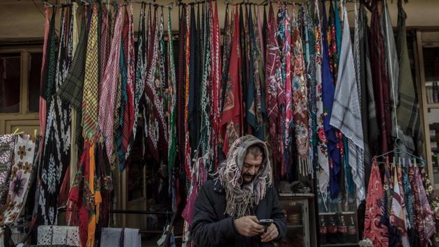A shop owner checks his phone in Hasankeyf. Confronted with the imminent flooding of their town and a hundred villages, the 3,000 habitants of Hasankeyf are divided. While some are angry at the sacrifice being imposed on them, others are impatient for the economic benefits promised by Ankara. (Bulent Kilic / AFP) A shop owner checks his phone in Hasankeyf. Confronted with the imminent flooding of their town and a hundred villages, the 3,000 habitants of Hasankeyf are divided. While some are angry at the sacrifice being imposed on them, others are impatient for the economic benefits promised by Ankara. (Bulent Kilic / AFP)