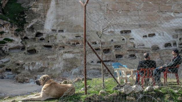 Residents sit in front of historical caves in Hasankeyf. Assyrians, Romans, Seljuks... the empires that washed over this region have left an exceptional heritage, not least the thousands of caves that were inhabited as recently as the 1970s and are a major tourist draw. The government dismisses criticism, arguing that everything has been done to save the monuments. (Bulent Kilic / AFP) Residents sit in front of historical caves in Hasankeyf. Assyrians, Romans, Seljuks... the empires that washed over this region have left an exceptional heritage, not least the thousands of caves that were inhabited as recently as the 1970s and are a major tourist draw. The government dismisses criticism, arguing that everything has been done to save the monuments. (Bulent Kilic / AFP)