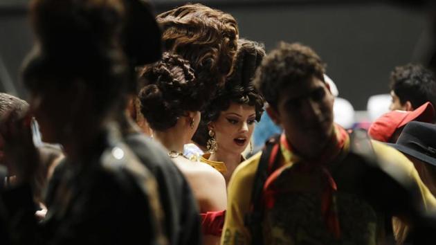 Models wait to take the catwalk prior to the unveiling of the Moschino fall-winter 2019/20 men’s collection and women’s pre-collection (AP)