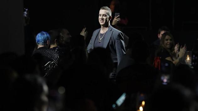 Moschino fashion designer Jeremy Scott acknowledges the crowd on the catwalk at the end of the fall-winter 2019/20 men’s collection and women’s pre-collection (AP)