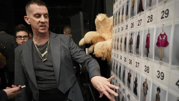 Jeremy Scott points to a board with photos of his creations prior to the start of the fall-winter 2019/20 men’s collection and women’s pre-collection (AP)