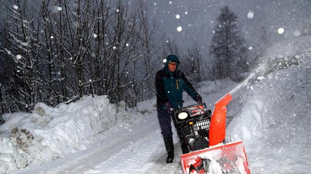 A man removes snow from a road in Eisenerz, Austria. Hundreds of Austrians were stuck in their homes due to blocked roads and some regions experienced power outages after trees took down power lines. Schools in some regions remained closed for a second day on Wednesday and homeowners were advised to remove snow from their roofs after several buildings collapsed. (Lisi Neisner / REUTERS) A man removes snow from a road in Eisenerz, Austria. Hundreds of Austrians were stuck in their homes due to blocked roads and some regions experienced power outages after trees took down power lines. Schools in some regions remained closed for a second day on Wednesday and homeowners were advised to remove snow from their roofs after several buildings collapsed. (Lisi Neisner / REUTERS)