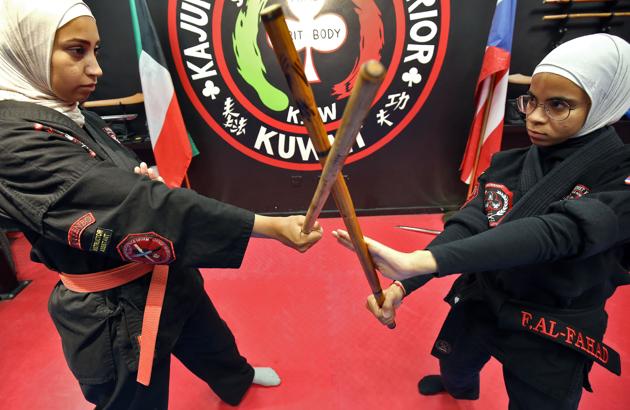 Asma Hasnawi (L) and Fai al-Fahad, Kajukenbo assistant-master, practise in Kuwait City. Hasnawi and her daughter Riham spend more than 12 hours a week learning kajukenbo, a mixed martial art the mother says boosts her child’s confidence and thwarts bullying. The sport’s name was derived from the various forms of martial arts it includes: karate (KA), judo and jujitsu (JU), kenpo (KEN) and boxing (BO). (Yasser Al-Zayyat / AFP) Asma Hasnawi (L) and Fai al-Fahad, Kajukenbo assistant-master, practise in Kuwait City. Hasnawi and her daughter Riham spend more than 12 hours a week learning kajukenbo, a mixed martial art the mother says boosts her child’s confidence and thwarts bullying. The sport’s name was derived from the various forms of martial arts it includes: karate (KA), judo and jujitsu (JU), kenpo (KEN) and boxing (BO). (Yasser Al-Zayyat / AFP)