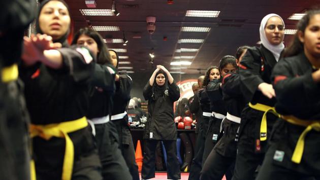 In a small hall, women and girls in black uniforms gather to learn the basics of self-defence. On their left sleeves are the flags of Kuwait and the US state of Hawaii, where the hybrid martial art of kajukenbo was developed in the 1940s. Each form teaches techniques that can be used to fend off an attack, said Hasnawi, 33, who stands in class alongside her 12-year-old daughter and other girls. (Yasser Al-Zayyat / AFP) In a small hall, women and girls in black uniforms gather to learn the basics of self-defence. On their left sleeves are the flags of Kuwait and the US state of Hawaii, where the hybrid martial art of kajukenbo was developed in the 1940s. Each form teaches techniques that can be used to fend off an attack, said Hasnawi, 33, who stands in class alongside her 12-year-old daughter and other girls. (Yasser Al-Zayyat / AFP)