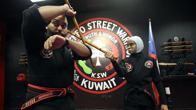 The students closely watch their instructor Faisal al-Gharib (L), as he explains how to counter an attack. In another instance, the instructor’s son mimicked an attack with a wooden knife on one of the more experienced pupils. The student explained: “I pretend that I have surrendered... and then I grab his hand on my neck, push it down and move it away.” (Yasser Al-Zayyat / AFP) The students closely watch their instructor Faisal al-Gharib (L), as he explains how to counter an attack. In another instance, the instructor’s son mimicked an attack with a wooden knife on one of the more experienced pupils. The student explained: “I pretend that I have surrendered... and then I grab his hand on my neck, push it down and move it away.” (Yasser Al-Zayyat / AFP)