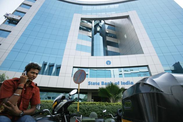 A man speaks on a mobile phone outside the State Bank of India building in Mumbai, India. Photographer: ADEEL HALIM (BLOOMBERG NEWS) A man speaks on a mobile phone outside the State Bank of India building in Mumbai, India. Photographer: ADEEL HALIM (BLOOMBERG NEWS)