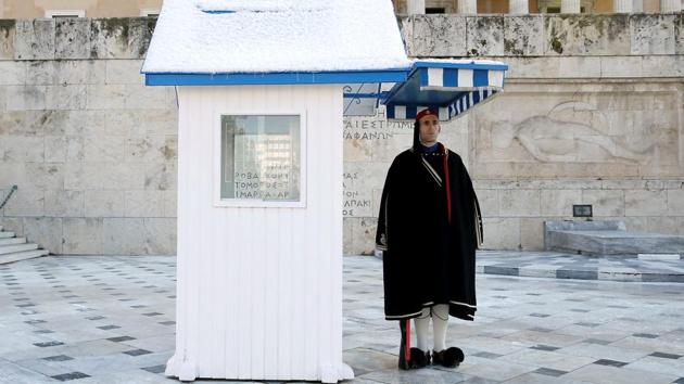 A member of Greek Presidential guard wears a traditional winter cape to protect from low temperatures in Athens. The snowfall prompted authorities to close schools and courthouses, while many public offices and banks provided minimal services. Many employees stayed away from work as the snow created traffic problems for a populace unused to driving in freezing conditions. (Costas Baltas / REUTERS) A member of Greek Presidential guard wears a traditional winter cape to protect from low temperatures in Athens. The snowfall prompted authorities to close schools and courthouses, while many public offices and banks provided minimal services. Many employees stayed away from work as the snow created traffic problems for a populace unused to driving in freezing conditions. (Costas Baltas / REUTERS)