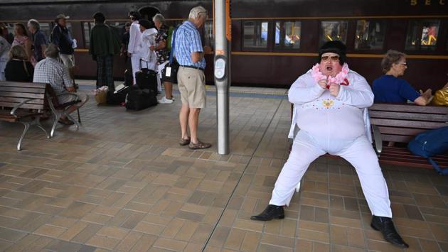 An Elvis fan yawns as he waits at Central station before boarding a train to The Parkes Elvis Festival. Regular attendee Jenny Dollin -- who wore a plastic cap shaped like Elvis’ pompadour hairstyle, a white tunic top and bell-bottoms -- said she loved the energy and excitement of the festival. (Peter Parks / AFP) An Elvis fan yawns as he waits at Central station before boarding a train to The Parkes Elvis Festival. Regular attendee Jenny Dollin -- who wore a plastic cap shaped like Elvis’ pompadour hairstyle, a white tunic top and bell-bottoms -- said she loved the energy and excitement of the festival. (Peter Parks / AFP)