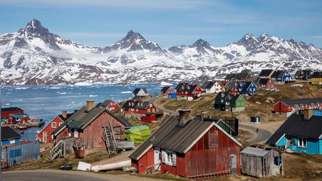 Snow covered mountains rise above the harbour and town of Tasiilaq, Greenland. Nestled between icy peaks and lapped in frozen ocean waters, the tiny town in southeastern Greenland is home to some 2,000 people. Colorful wooden houses dot the sub-Arctic landscape battered by one of the harshest climates on the planet. (Lucas Jackson / REUTERS) Snow covered mountains rise above the harbour and town of Tasiilaq, Greenland. Nestled between icy peaks and lapped in frozen ocean waters, the tiny town in southeastern Greenland is home to some 2,000 people. Colorful wooden houses dot the sub-Arctic landscape battered by one of the harshest climates on the planet. (Lucas Jackson / REUTERS)