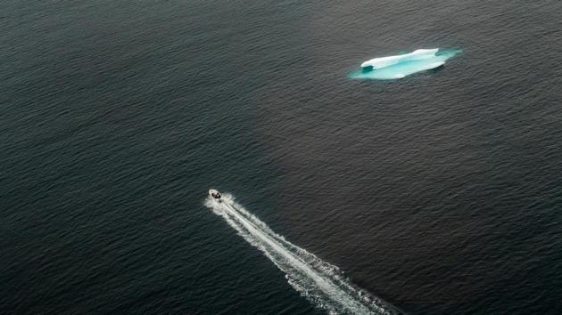 A small skiff motors past an iceberg in the open ocean. There is a silver lining. Ice retreating earlier in the year is freeing access to areas that were previously locked away for longer, and it has allowed Moeller to kick off boat tours for tourists much earlier in the summer season, said the 45-year-old Dane. “Instead of having three months, we can go four months or five months,” Moeller said. (Lucas Jackson / REUTERS) A small skiff motors past an iceberg in the open ocean. There is a silver lining. Ice retreating earlier in the year is freeing access to areas that were previously locked away for longer, and it has allowed Moeller to kick off boat tours for tourists much earlier in the summer season, said the 45-year-old Dane. “Instead of having three months, we can go four months or five months,” Moeller said. (Lucas Jackson / REUTERS)