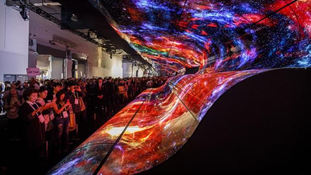 Attendees take photographs of a curved electronic display wall at the entrance to the LG Electronics Inc. booth at the 2019 Consumer Electronics Show (CES) in Las Vegas, Nevada. (Patrick T. Fallon / Bloomberg) Attendees take photographs of a curved electronic display wall at the entrance to the LG Electronics Inc. booth at the 2019 Consumer Electronics Show (CES) in Las Vegas, Nevada. (Patrick T. Fallon / Bloomberg)
