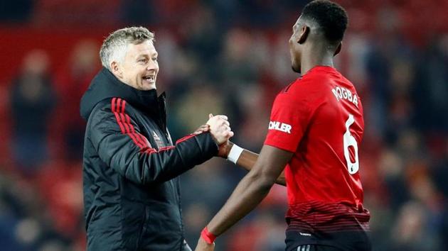 File image of Manchester United's Paul Pogba and interim manager Ole Gunnar Solskjaer.(Reuters)