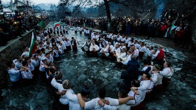 Bulgarian men perform the traditional “Horo” dance in the icy winter waters of the Tundzha river in the town of Kalofer, as part of Epiphany Day celebrations.As a tradition, an Eastern Orthodox priest throws a cross in the river and it is believed that the one who retrieves it will be healthy throughout the year as well as all those who dance in the icy waters. (Dimitar Dilkoff / AFP) Bulgarian men perform the traditional “Horo” dance in the icy winter waters of the Tundzha river in the town of Kalofer, as part of Epiphany Day celebrations.As a tradition, an Eastern Orthodox priest throws a cross in the river and it is believed that the one who retrieves it will be healthy throughout the year as well as all those who dance in the icy waters. (Dimitar Dilkoff / AFP)