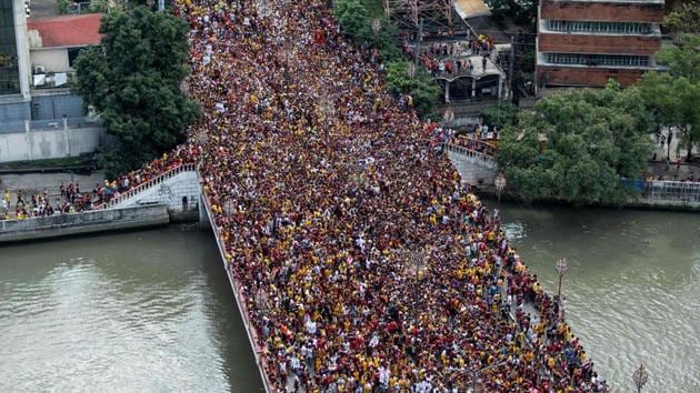 Devotees carry the statue of the Black Nazarene to the carriage at the start of the annual religious procession in Manila, Philippines. Throngs of believers flung themselves at a historic statue of Jesus Christ as it inched through Manila for an annual procession that is one of the world's biggest shows of Catholic zeal. (Noel Celis / AFP) Devotees carry the statue of the Black Nazarene to the carriage at the start of the annual religious procession in Manila, Philippines. Throngs of believers flung themselves at a historic statue of Jesus Christ as it inched through Manila for an annual procession that is one of the world's biggest shows of Catholic zeal. (Noel Celis / AFP)