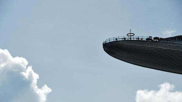 People are seen on top of the Marina Bay Sands SkyPark observation deck in Singapore. (Roslan Rahman / AFP) People are seen on top of the Marina Bay Sands SkyPark observation deck in Singapore. (Roslan Rahman / AFP)