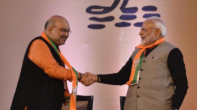 BJP president Amit Shah with Prime Minister Narendra Modi at the BJP national executive meet in New Delhi.(Sanchit Khanna/HT PHOTO)