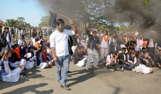 College students block a highway to protest against the Citizenship Amendment Bill in Assam’s Dibrugarh on Saturday.(PTI Photo)