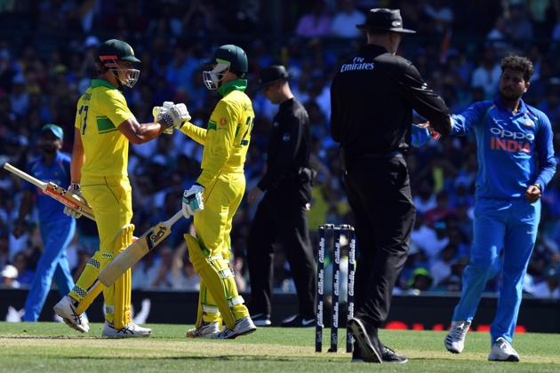 Australia's batsman Peter Handscomb (C) celebrates reaching his half century (50 runs) with a teammate Marcus Stoinis during the first one-day International (ODI) match between Australia and India at the Sydney Cricket Ground. (AFP)