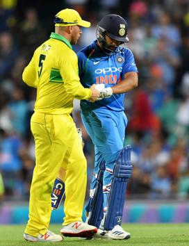 Australia's captain Aaron Finch (L) shakes hands with India's batsman Rohit Sharma after his dismissal during the first one-day international (ODI) match between Australia and India at the Sydney Cricket Ground (AFP)