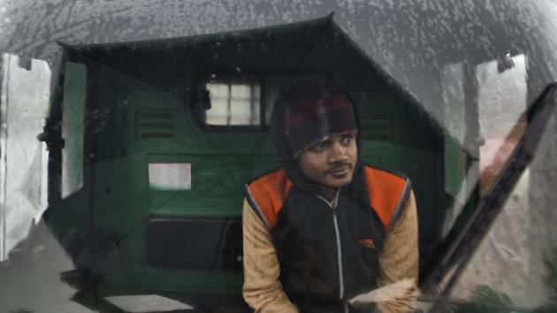 A driver seen inside a vehicle during light rainfall on a winter morning, at Okhla vegetable market, in New Delhi. (Burhaan Kinu / HT Photo) A driver seen inside a vehicle during light rainfall on a winter morning, at Okhla vegetable market, in New Delhi. (Burhaan Kinu / HT Photo)