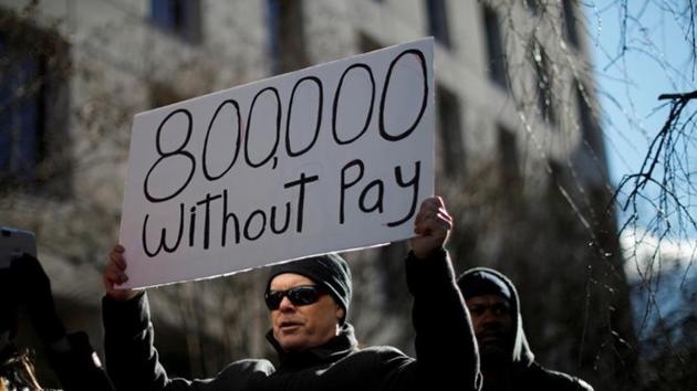 A demonstrator holds a sign, signifying hundreds of thousands of federal employees who won’t be receiving their paychecks as a result of the partial government shutdown, during a ‘Rally to End the Shutdown’ in Washington, US. (REUTERS) A demonstrator holds a sign, signifying hundreds of thousands of federal employees who won’t be receiving their paychecks as a result of the partial government shutdown, during a ‘Rally to End the Shutdown’ in Washington, US. (REUTERS)