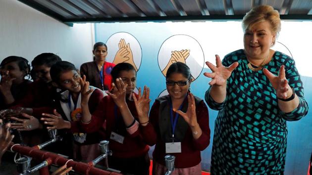 Norway's Prime Minister Erna Solberg gestures after washing her hands with the schoolgirls during her visit to a government-run school in Ghaziabad, Uttar Pradesh. (Anushree Fadnavis / REUTERS) Norway's Prime Minister Erna Solberg gestures after washing her hands with the schoolgirls during her visit to a government-run school in Ghaziabad, Uttar Pradesh. (Anushree Fadnavis / REUTERS)