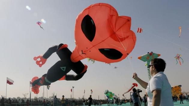 A participant flies a huge kite during the International Kite Festival, at Sabarmati riverfront in Ahmedabad, Gujarat. (Siddharaj Solanki / HT Photo) A participant flies a huge kite during the International Kite Festival, at Sabarmati riverfront in Ahmedabad, Gujarat. (Siddharaj Solanki / HT Photo)