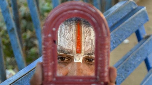 A sadhu applies sandalwood paste on his forehead near the Vindhyavasini temple ahead of Makar Sankranti festival in Mirzapur, Uttar Pradesh. (PTI) A sadhu applies sandalwood paste on his forehead near the Vindhyavasini temple ahead of Makar Sankranti festival in Mirzapur, Uttar Pradesh. (PTI)