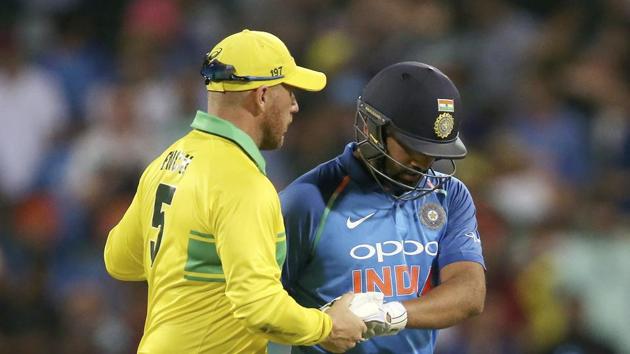 Australia's Aaron Finch, left, shakes hands with India's Rohit Sharma, right, after he was caught out against during their one day international cricket match in Sydney(AP)