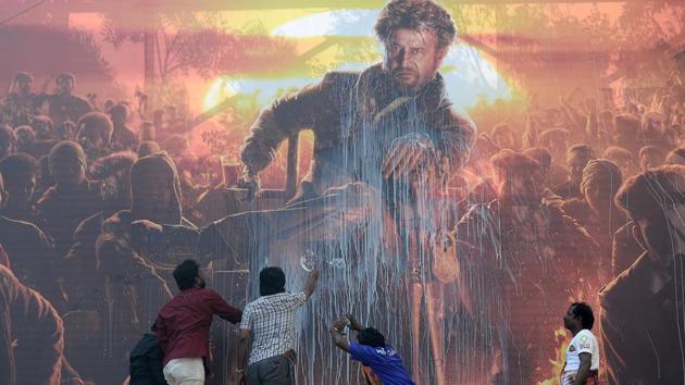 People spray milk on a billboard displaying the picture of actor Rajinikanth before attending the show of the new Tamil-language film Pettai in Chennai, Tamil Nadu. (Arun Sankar / AFP) People spray milk on a billboard displaying the picture of actor Rajinikanth before attending the show of the new Tamil-language film Pettai in Chennai, Tamil Nadu. (Arun Sankar / AFP)