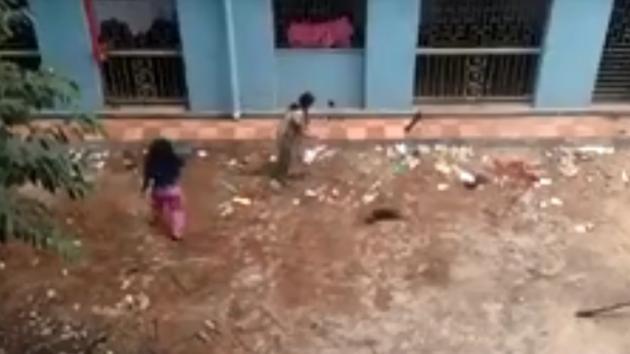 A video grab shows two women clobbering 16 puppies to death in Kolkata.(Sourced from Facebook)