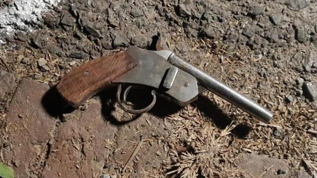 A gun at an encounter site in Noida in Uttar Pradesh.(HT Photo)