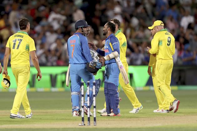 India's M.S. Dhoni (7) and teammate Dinesh Karthik celebrate their win over Australia during their one day international cricket match in Adelaide. (AP)