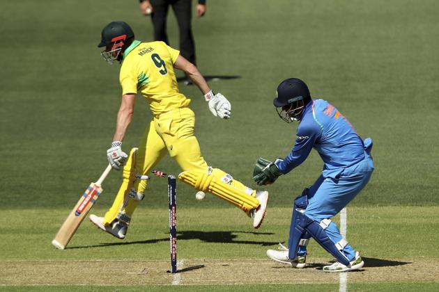 India's M.S. Dhoni, right, attempts a runout of Australia's Shaun Marsh during their one day international cricket match in Adelaide. (AP)