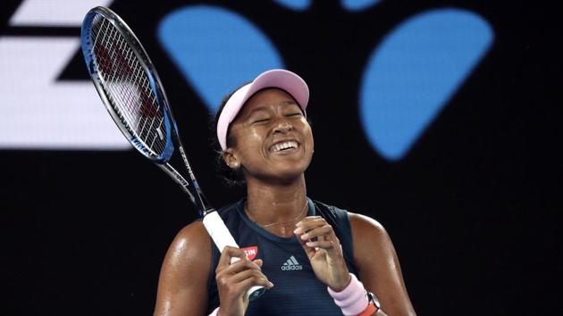 Japan's Naomi Osaka smiles during her first round match against Poland's Magda Linette at the Australian Open.(AP)