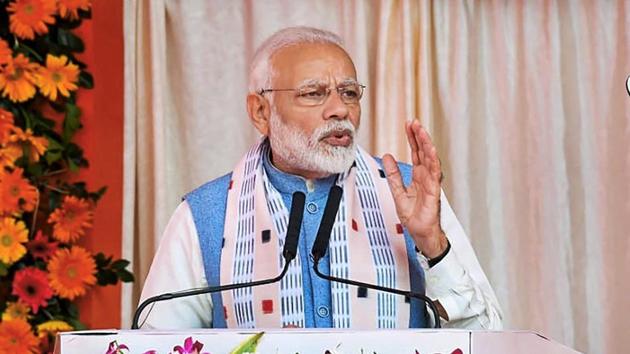 Prime Minister Narendra Modi addresses during the inauguration of various projects in Balangir, Odisha. Modi has also inaugurated renovation and restoration works of the Nilamadhav and Siddheswar temples there. (PTI)