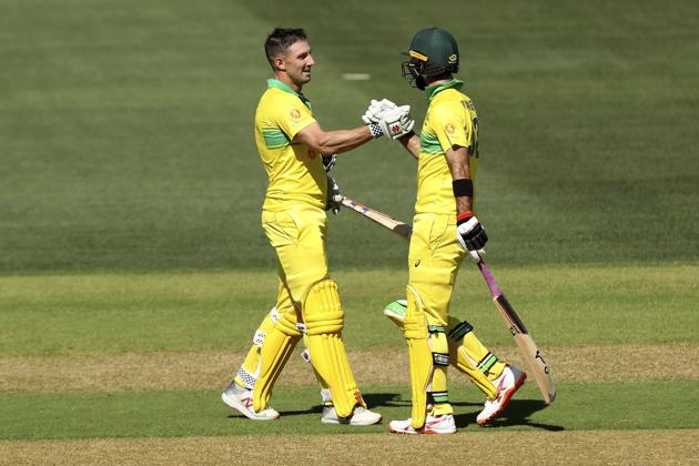 Australia's Shaun Marsh, left, celebrates his century with Glenn Maxwell during their one day international cricket match against Australia in Adelaide. (AP)
