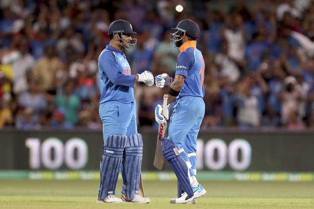 India's Virhat Kohli celebrates his 100 against Australia with teammate M.S. Dhoni during their one day international cricket match in Adelaide. (AP)