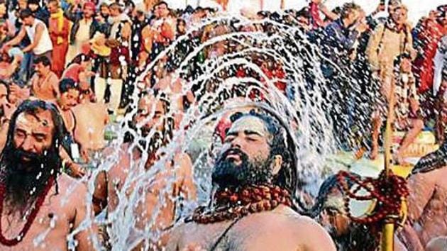 Naga Sadhus take a holy dip at Sangam on the auspicious Makar Sankranti day during the Kumbh Mela in Prayagraj(Sheeraz Rizvi/HT)