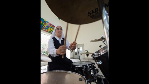 Sister Teresa, 33, drum player from Chile, participates in weekly rehearsals. After months of rehearsal, they held their first concert in the auditorium of the General Command of the Army, helping raise funds for a house for the order in Angola. The band has undergone several changes to its lineup since 2014, as sisters leave to fulfil their missionary role. (Cris Bouroncle / AFP) Sister Teresa, 33, drum player from Chile, participates in weekly rehearsals. After months of rehearsal, they held their first concert in the auditorium of the General Command of the Army, helping raise funds for a house for the order in Angola. The band has undergone several changes to its lineup since 2014, as sisters leave to fulfil their missionary role. (Cris Bouroncle / AFP)