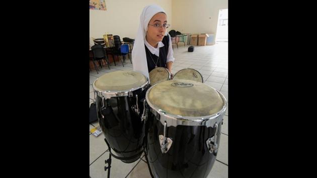 The 11-member band, which performs in Spanish, has previously played for crowds at Francis’ visits to Mexico and Peru. “We’re not just working in music, but we take the word of God and his consolation to the prisons, to the disabled,” said Sister Daniela, the drummer from Costa Rica. Tuesdays, when they are back in Peru, they bring food to the homeless on the streets. (Cris Bouroncle / AFP) The 11-member band, which performs in Spanish, has previously played for crowds at Francis’ visits to Mexico and Peru. “We’re not just working in music, but we take the word of God and his consolation to the prisons, to the disabled,” said Sister Daniela, the drummer from Costa Rica. Tuesdays, when they are back in Peru, they bring food to the homeless on the streets. (Cris Bouroncle / AFP)
