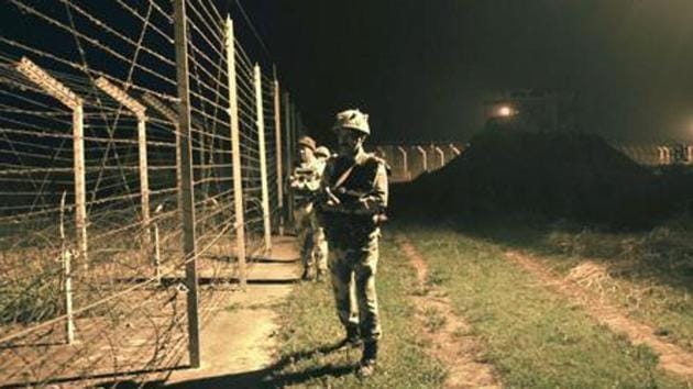 Border Security Force (BSF) soldiers standing guard during a night patrol near the fence at the India-Pakistan International Border at the outpost of Akhnoor sector, about 40 km from Jammu, on Sunday, October 2, 2016.(HT File Photo)