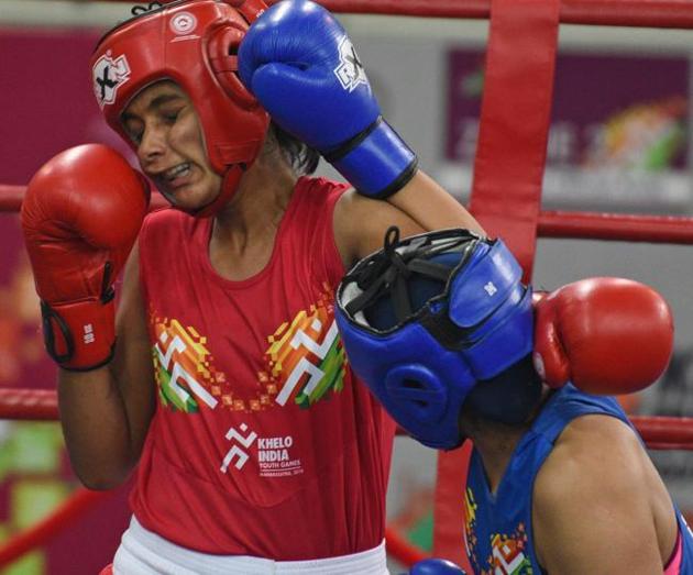 Sanika Sasane (red) of Maharashtra and Lalita of Rajasthan in action during U - 21 Girls Boxing quarter-final at Khelo India Youth Games 2019 at Shiv Chhatrapati sports complex Balewadi on Wednesday. (Pratham Gokhale/HT Photo) 