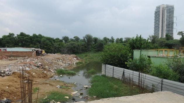 A view of Badshapur drain, in Gurugram. The GMDA plans to concretise the drain and boxing it using Reinforced Cement Concrete (RCC) pipes by July 2019.(Parveen Kumar/ HT File)