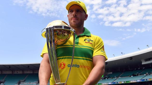Australian cricket captain Aaron Finch poses with the ICC Cricket World Cup trophy.(AFP)