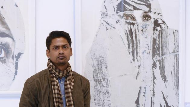Artist Jyotiprakash Sethy poses next to his artworks(Sarang Gupta/HT)