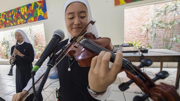 The band, which has so far visited 11 countries, including the United States, was formed in Lima in 2014 when the young musician nuns from different nationalities came together, said 24-year-old Sister Arisa (R), from Japan. “It was God’s plan that we come together,” said Arisa, a violinist. (Cris Bouroncle / AFP) The band, which has so far visited 11 countries, including the United States, was formed in Lima in 2014 when the young musician nuns from different nationalities came together, said 24-year-old Sister Arisa (R), from Japan. “It was God’s plan that we come together,” said Arisa, a violinist. (Cris Bouroncle / AFP)